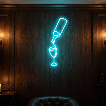 Photo of the 'Pouring Wine' neon sign glowing in ice blue against a stylish wine bar-inspired wall.