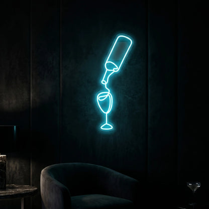 Photo of the 'Pouring Wine' neon sign glowing in ice blue against a stylish wine bar-inspired wall.