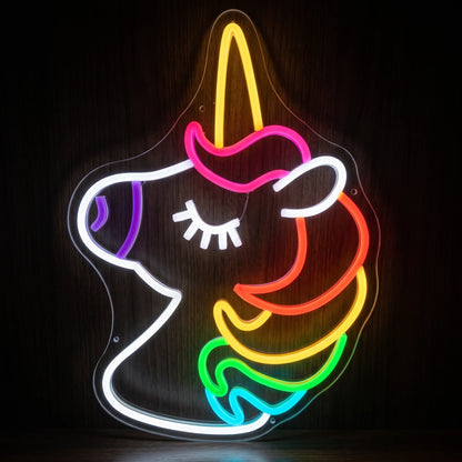 Rainbow Unicorn LED Neon Sign featuring a colorful unicorn profile with a glowing horn, closed eye and multicolor mane on clear acrylic backing.