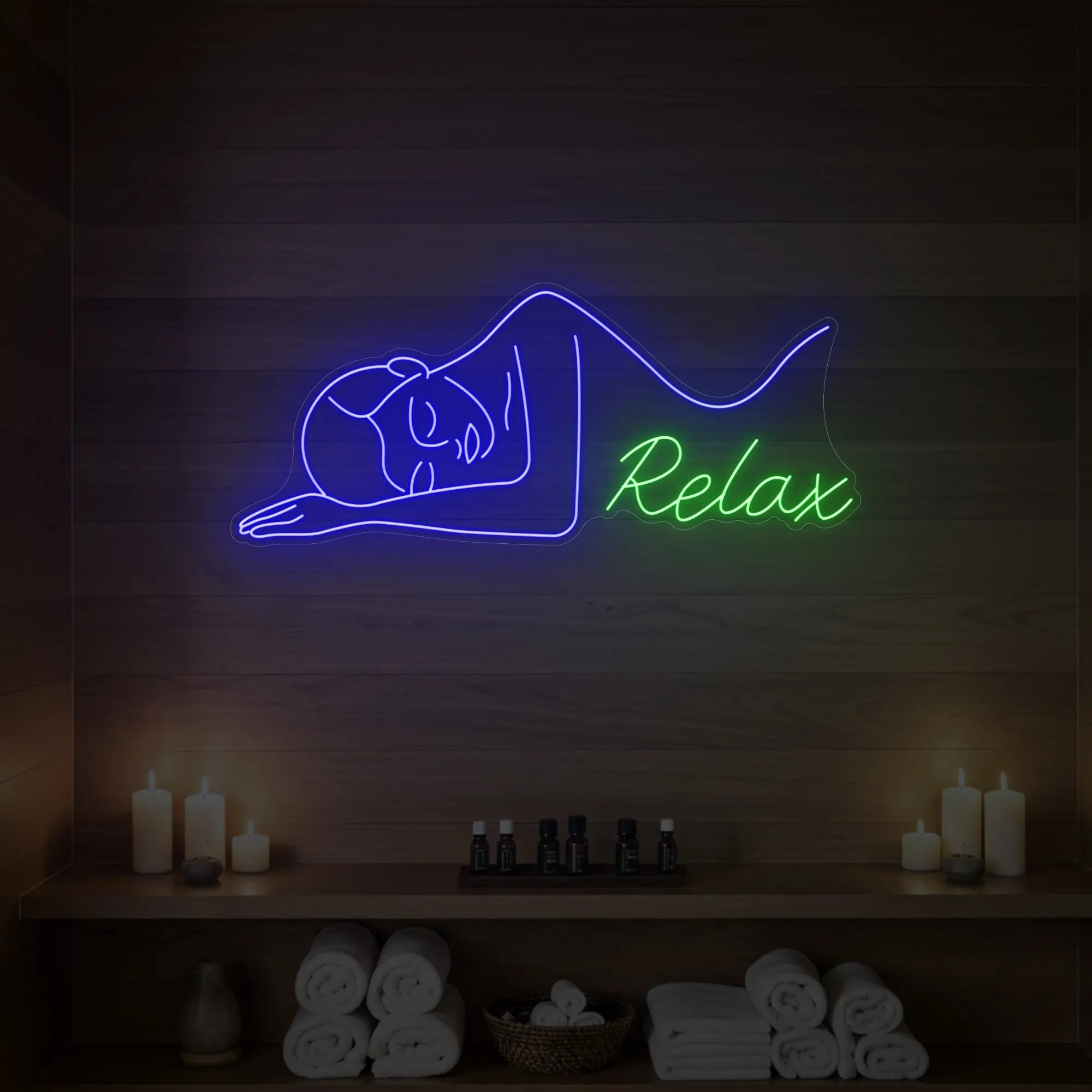 Photo of the 'Relax' neon sign glowing in deep blue and green against a styled interior wall.