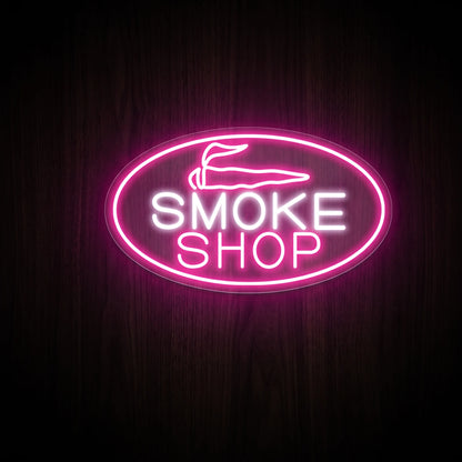Retro Smoke Shop oval LED neon sign featuring bold white lettering, a pink oval border, and a minimalist pre-roll icon on a clear acrylic backing.