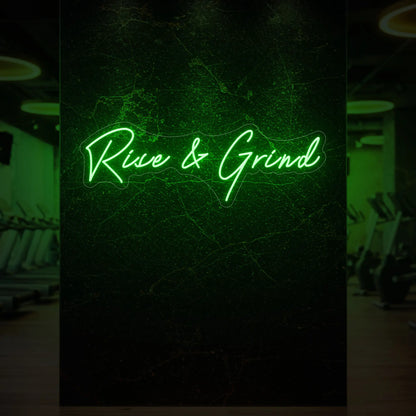  'Rise & Grind' neon sign glowing in green against a styled interior wall.