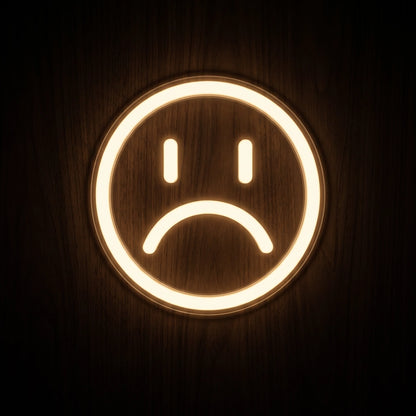 Sad Face LED neon sign featuring a simple circular face with two eyes and a frowning mouth glowing in warm white.