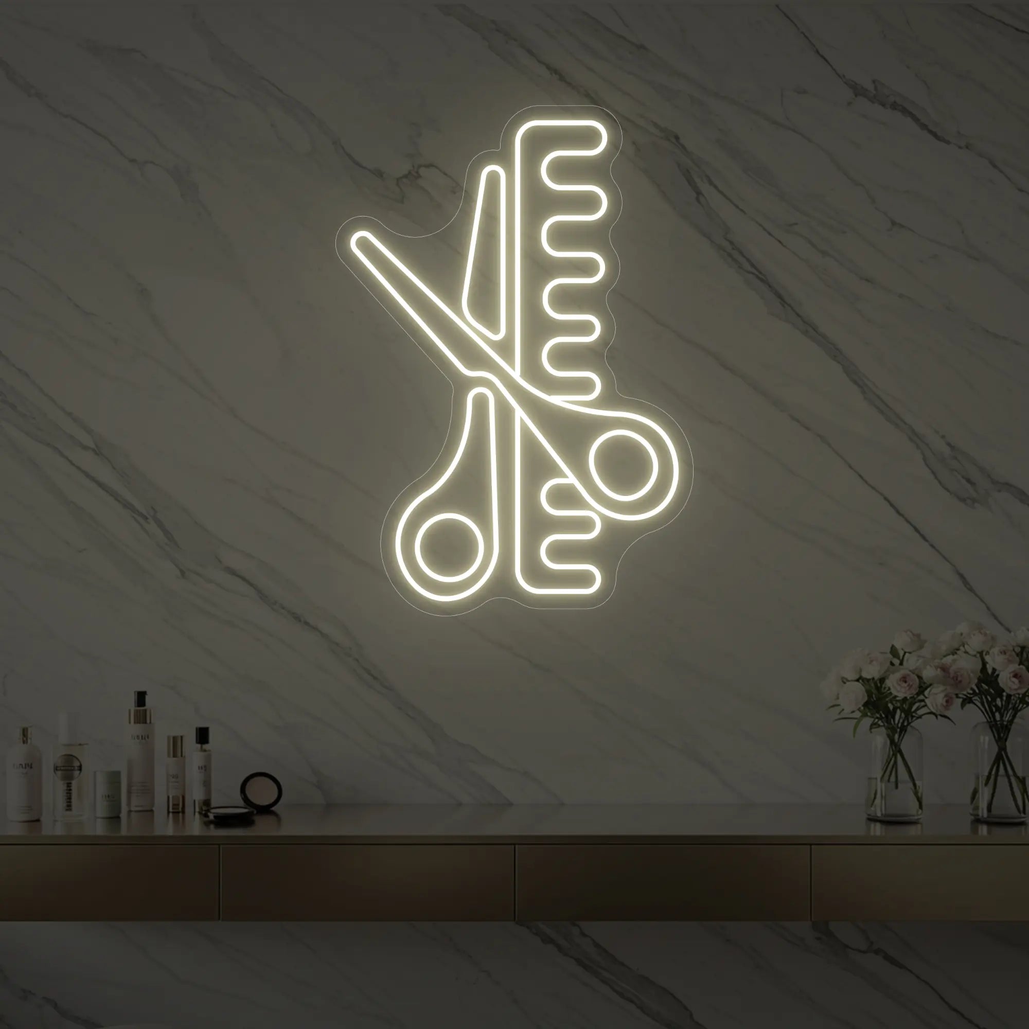 Photo of the 'Scissors and Comb' neon sign glowing in warm white against a styled interior wall.