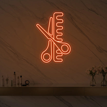 Photo of the 'Scissors and Comb' neon sign glowing in golden yellow against a styled interior wall.