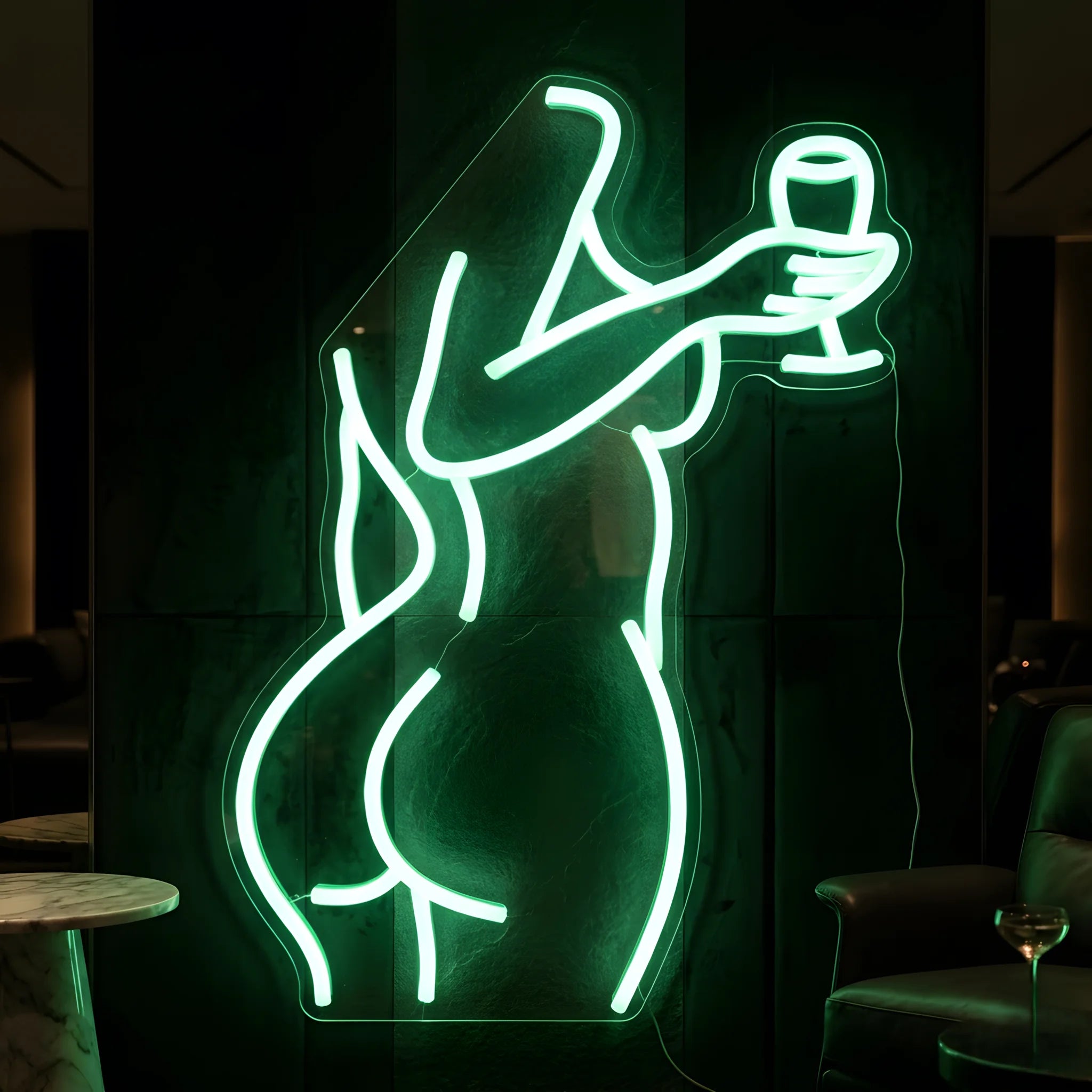 Photo of the 'Sexy Drink' neon sign glowing in green against a chic nightlife-inspired wall.