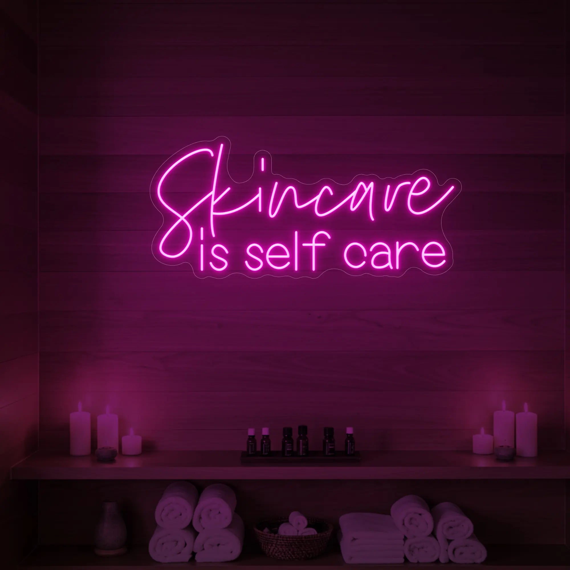 Photo of the 'Skincare is Self Care' neon sign glowing in light pink against a styled interior wall.