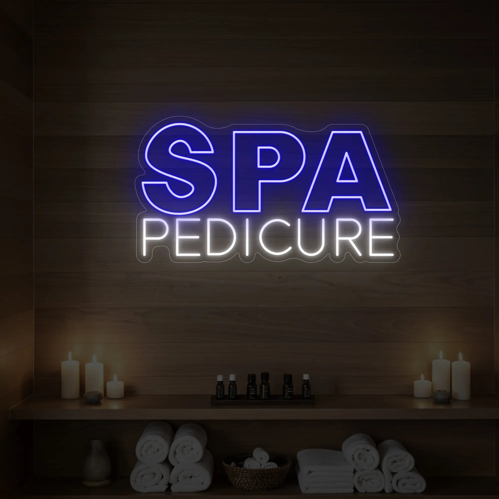 Photo of the 'Spa Pedicure' neon sign glowing in deep blue against a styled interior wall.

