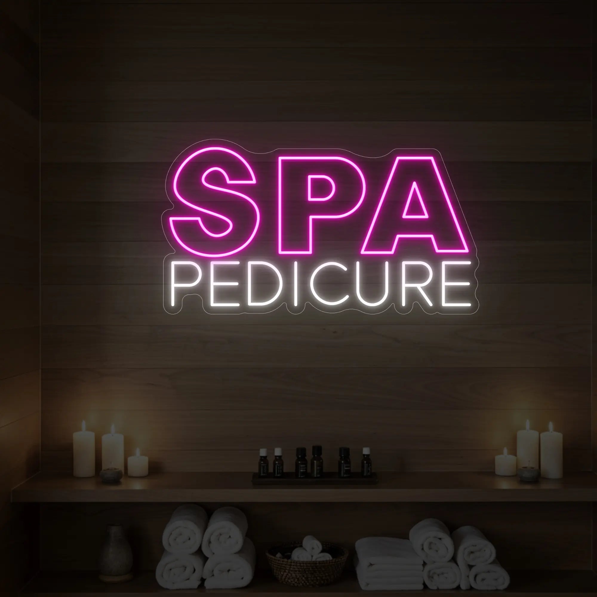 Photo of the 'Spa Pedicure' neon sign glowing in light pink against a styled interior wall.