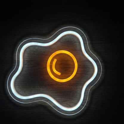 Sunny Side Up Egg LED neon sign with bright white fried egg outline and glowing yellow-orange yolk on clear acrylic backing.