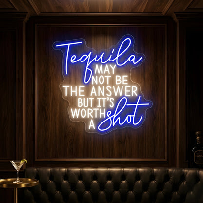 Photo of the 'Tequila May Not Be The Answer But It’s Worth a Shot' neon sign glowing in multi-color against a tequila bar-inspired wall.