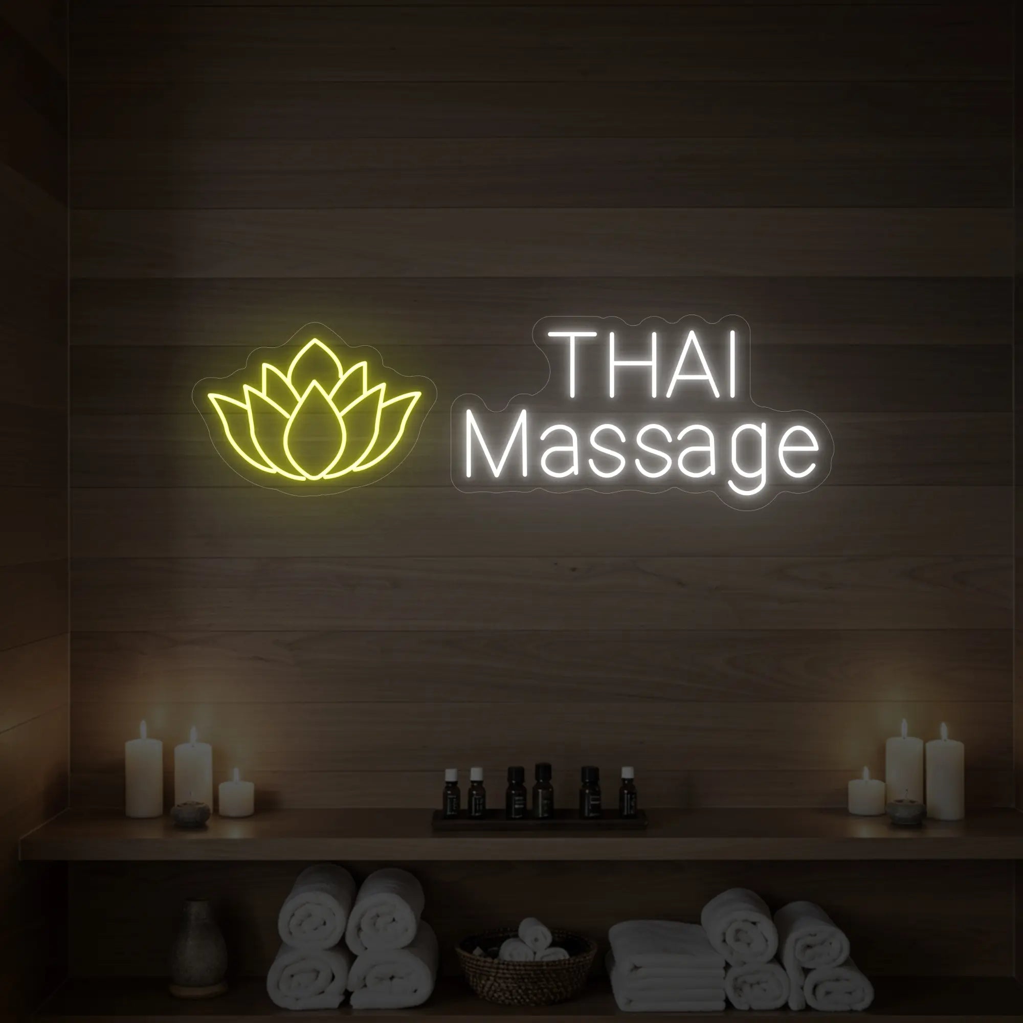Photo of the 'Thai Massage' neon sign glowing in lemon yellow against a styled interior wall.