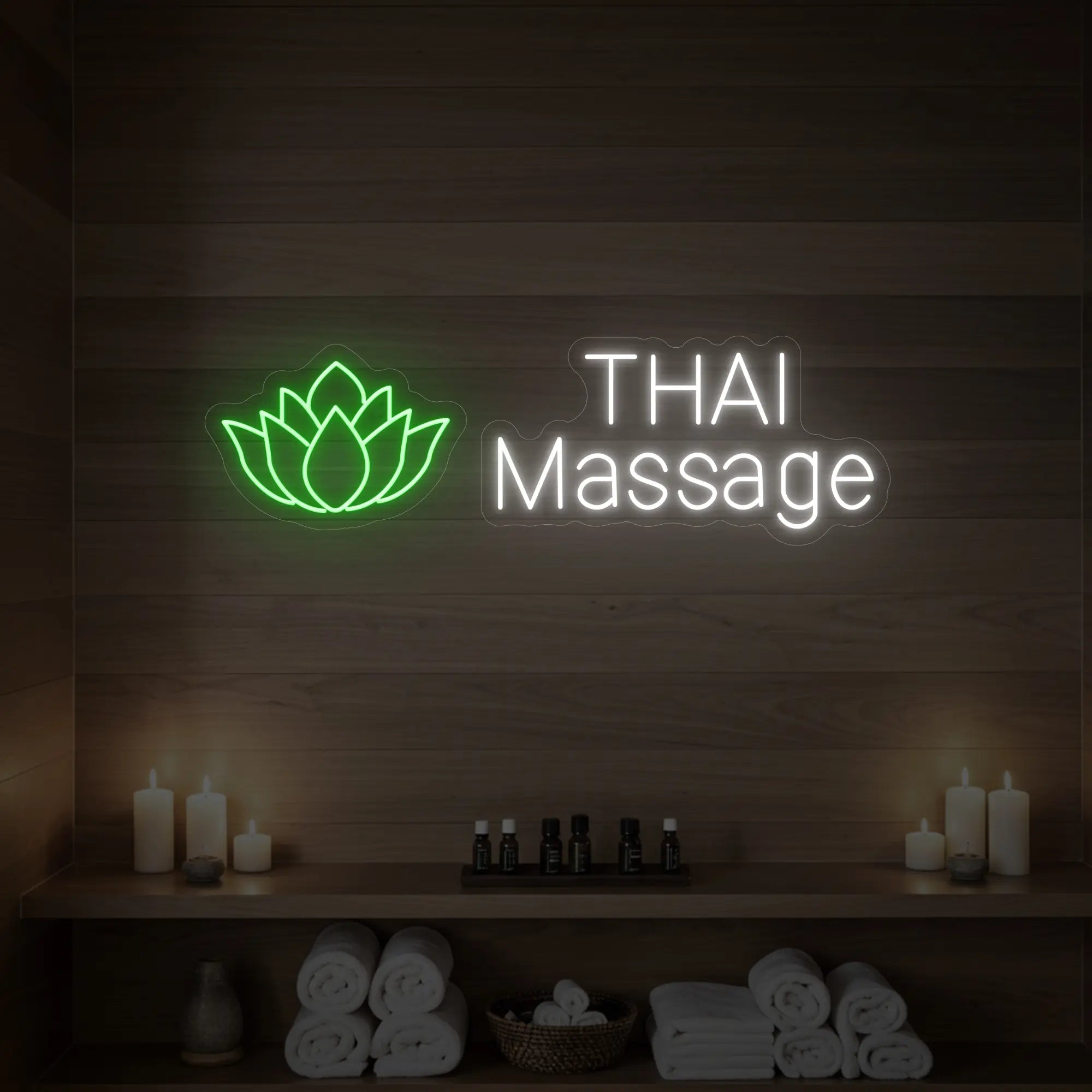Photo of the 'Thai Massage' neon sign glowing in green against a styled interior wall.