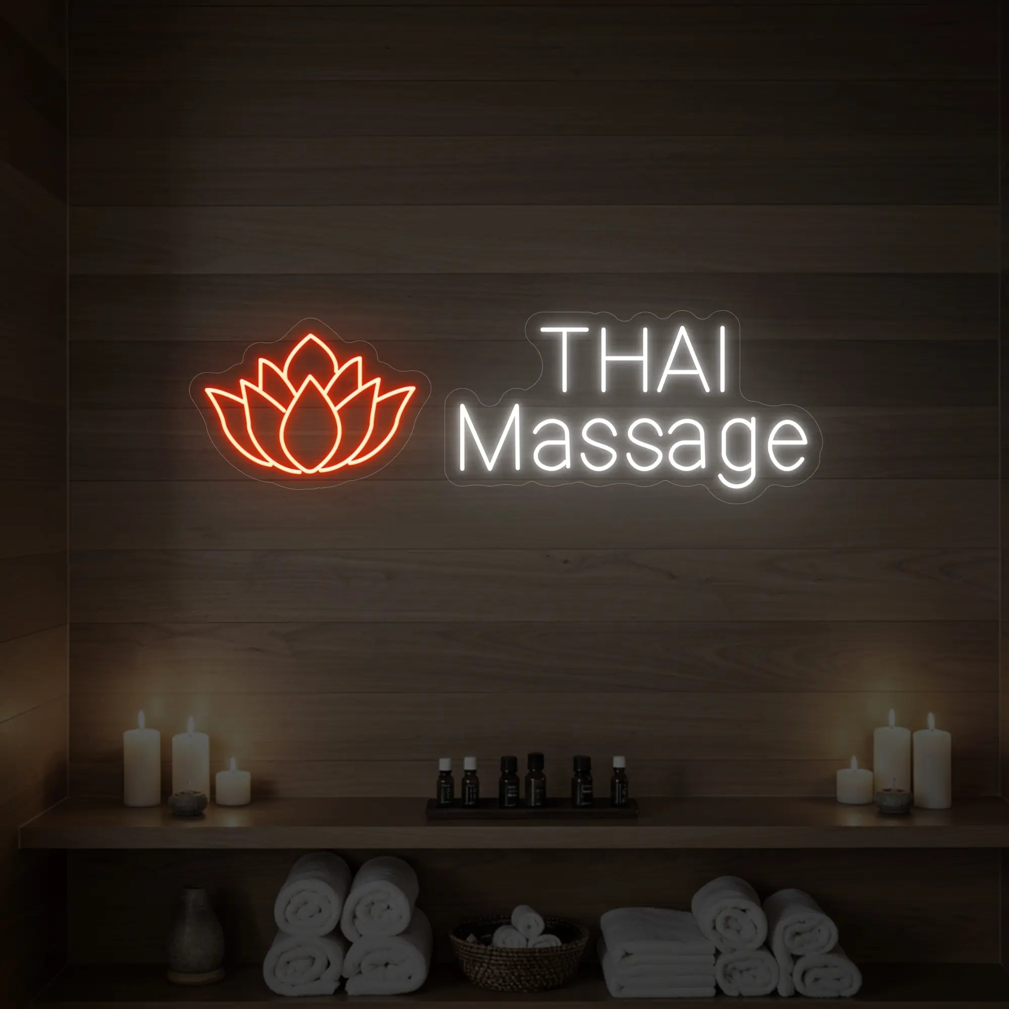 Photo of the 'Thai Massage' neon sign glowing in golden yellow against a styled interior wall.