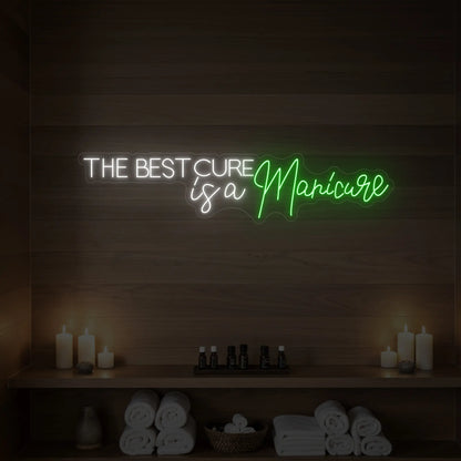 Photo of the 'The Best Cure is a Manicure' neon sign glowing in green against a styled interior wall.
