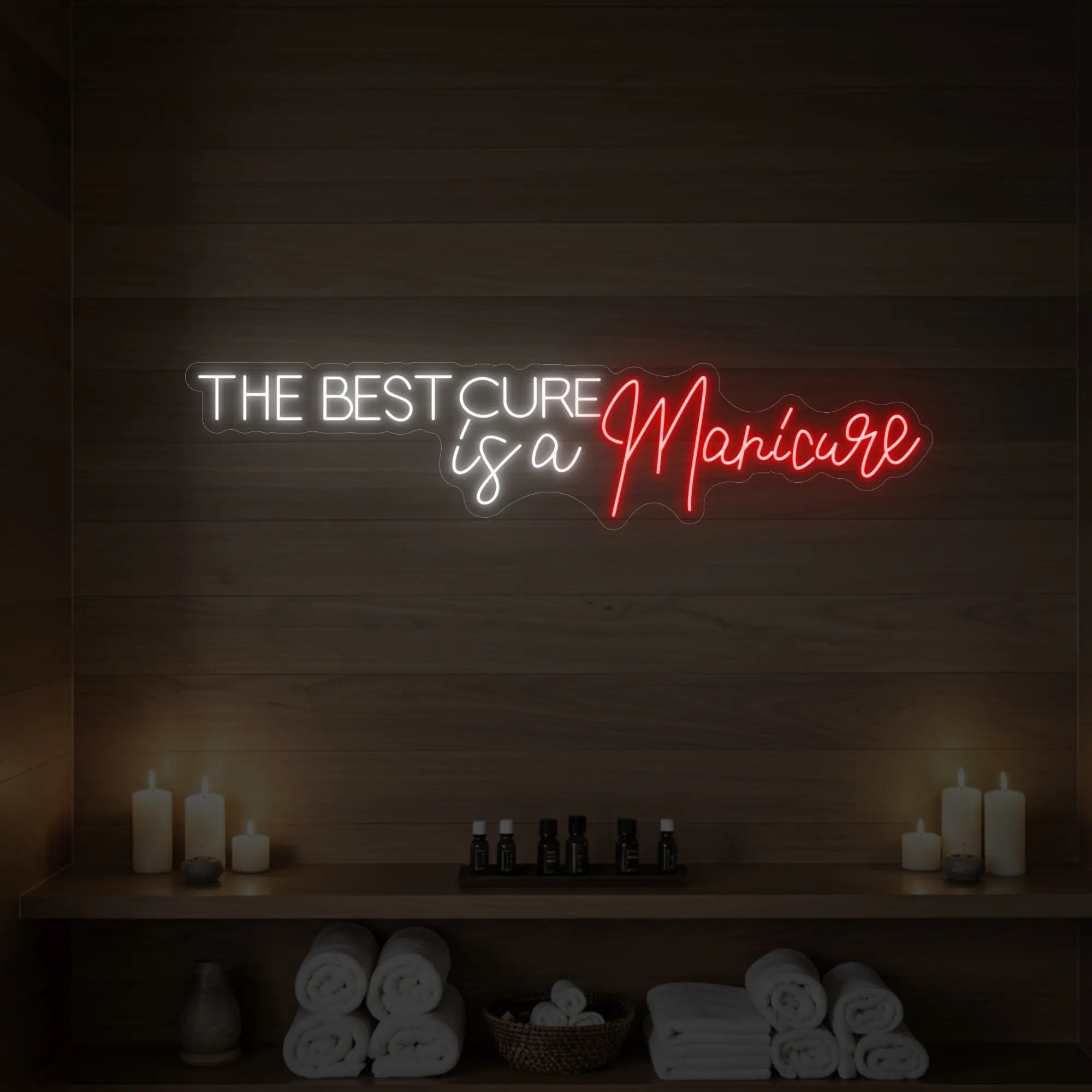 Photo of the 'The Best Cure is a Manicure' neon sign glowing in red against a styled interior wall.