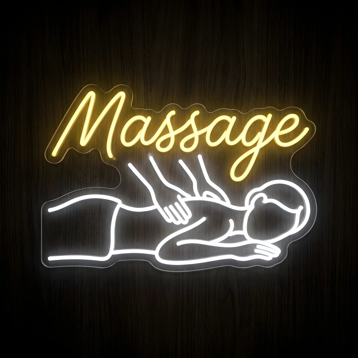 Therapeutic Body Massage LED Neon Sign featuring warm yellow cursive Massage lettering and a glowing white outline of a person receiving a back massage on clear cut-to-shape acrylic against a dark wooden wall.
