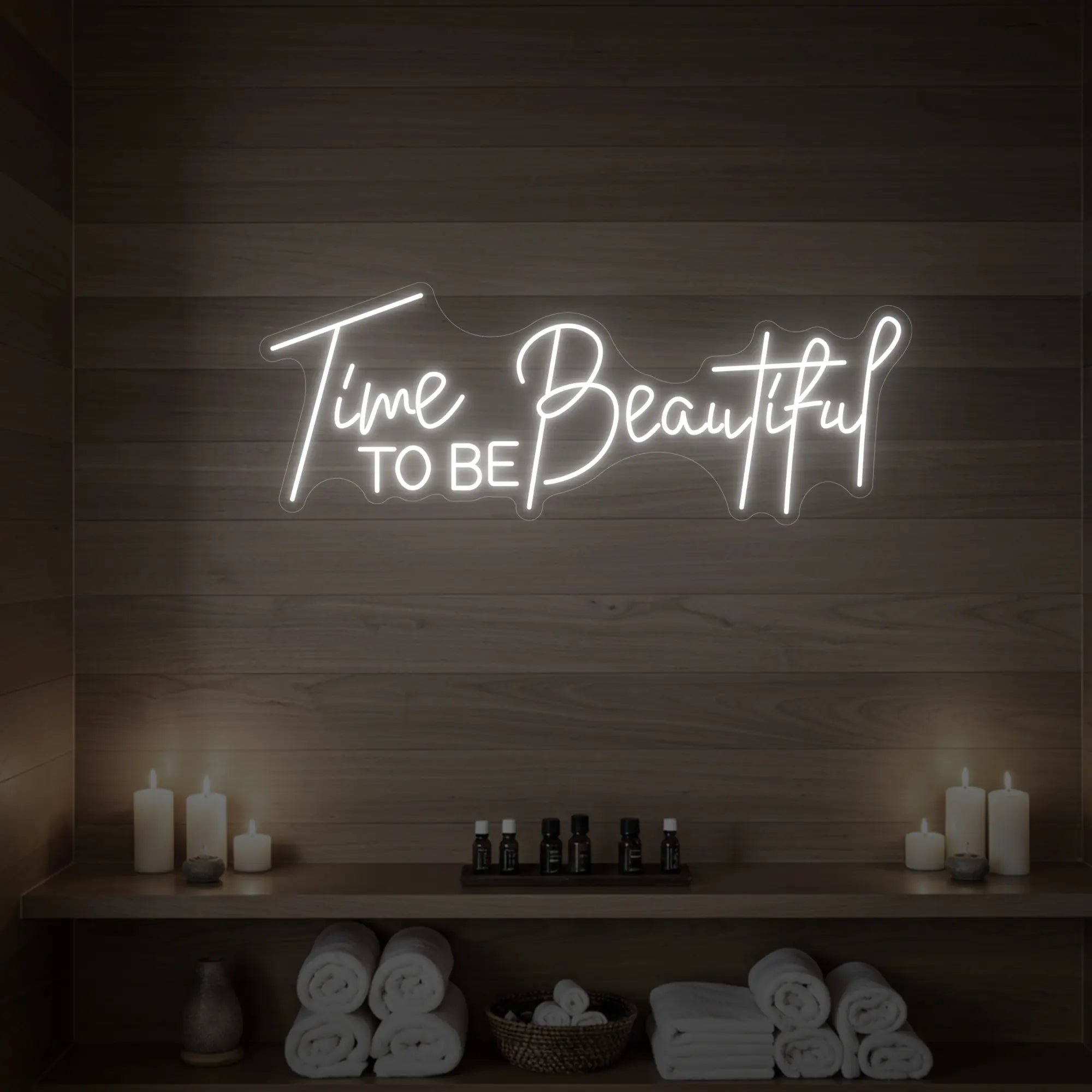 Photo of the 'TIME TO BE BEAUTIFUL' neon sign glowing in cool white against a styled interior wall.