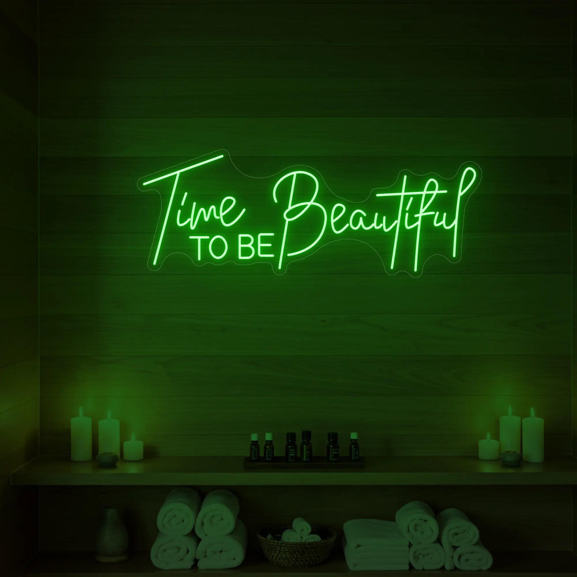 Photo of the 'TIME TO BE BEAUTIFUL' neon sign glowing in green against a styled interior wall.