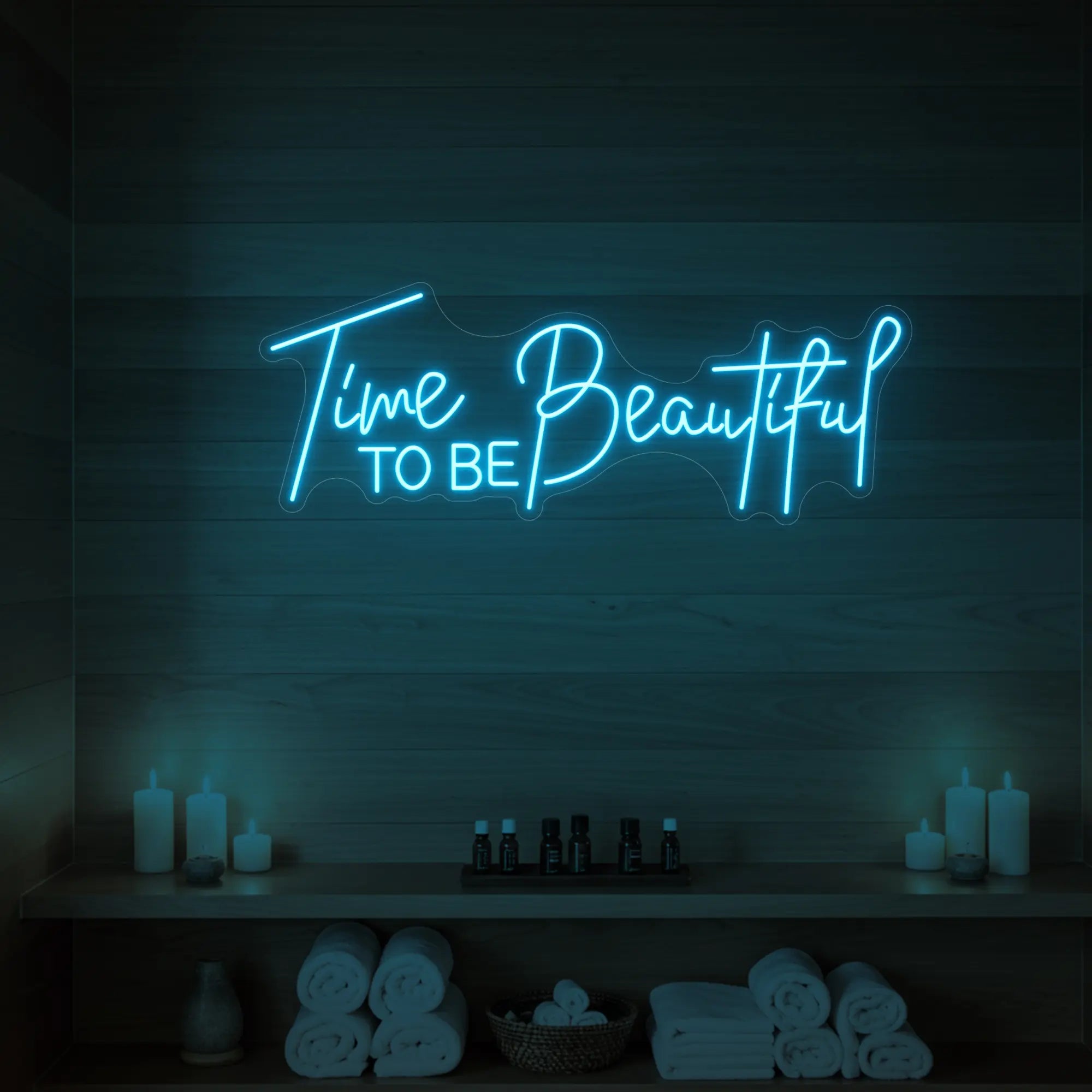 Photo of the 'TIME TO BE BEAUTIFUL' neon sign glowing in ice blue against a styled interior wall.