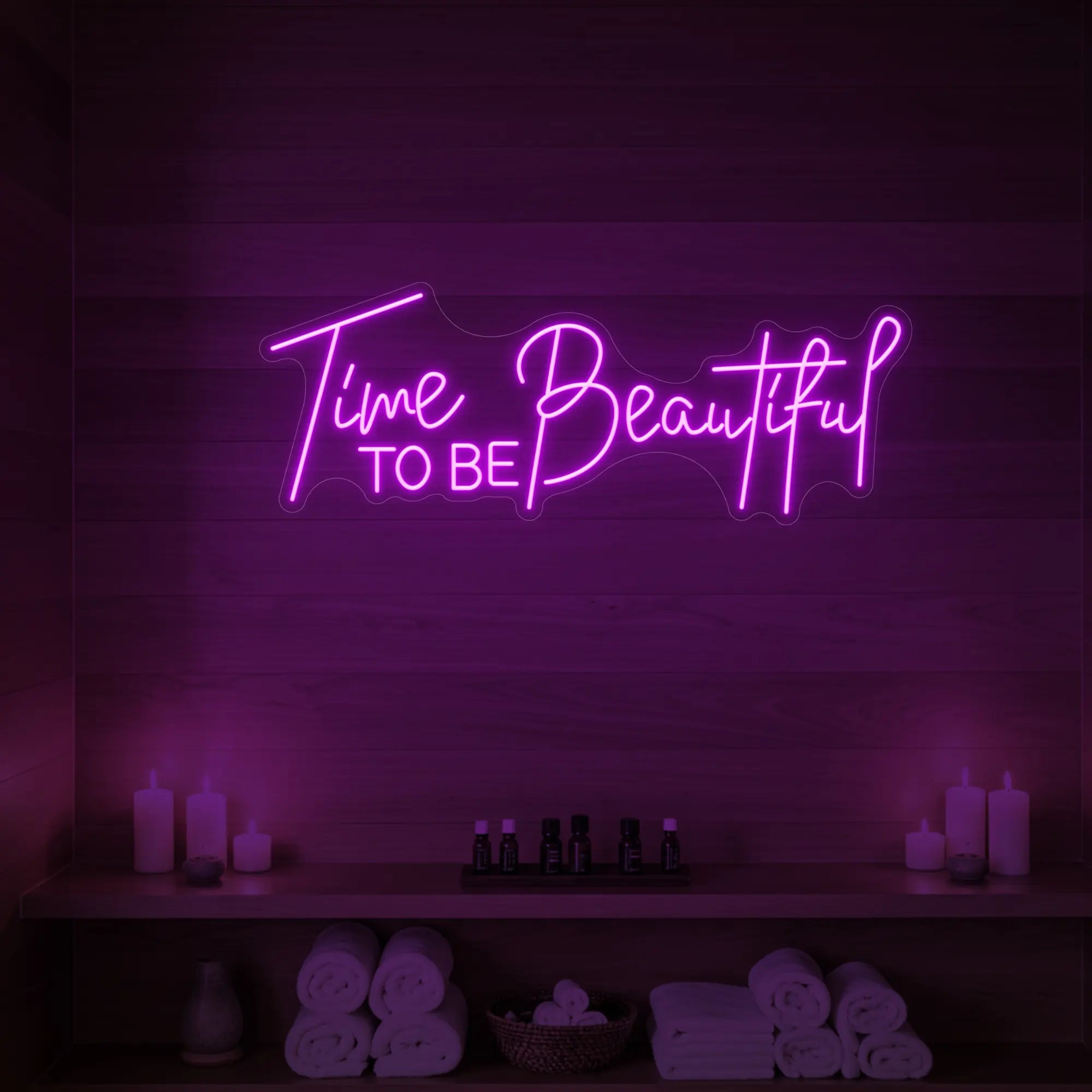 Photo of the 'TIME TO BE BEAUTIFUL' neon sign glowing in deep pink against a styled interior wall.