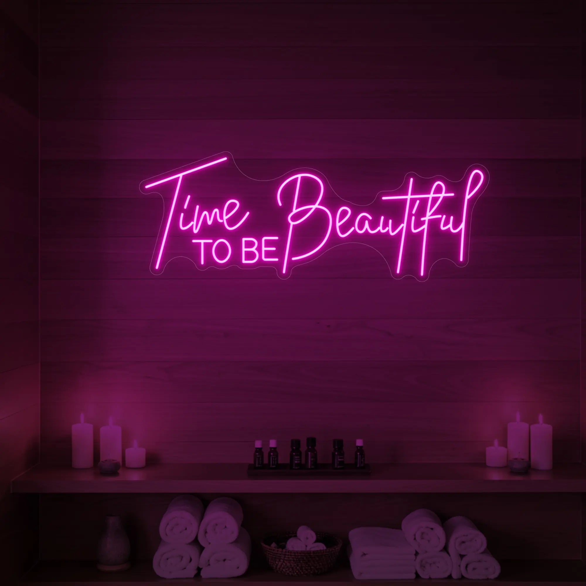 Photo of the 'TIME TO BE BEAUTIFUL' neon sign glowing in deep blue against a styled interior wall.