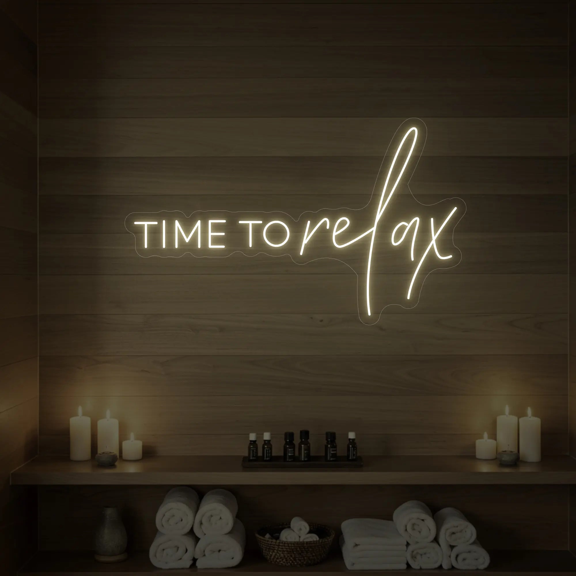 Photo of the 'TIME TO RELAX' neon sign glowing in warm white against a styled interior wall.