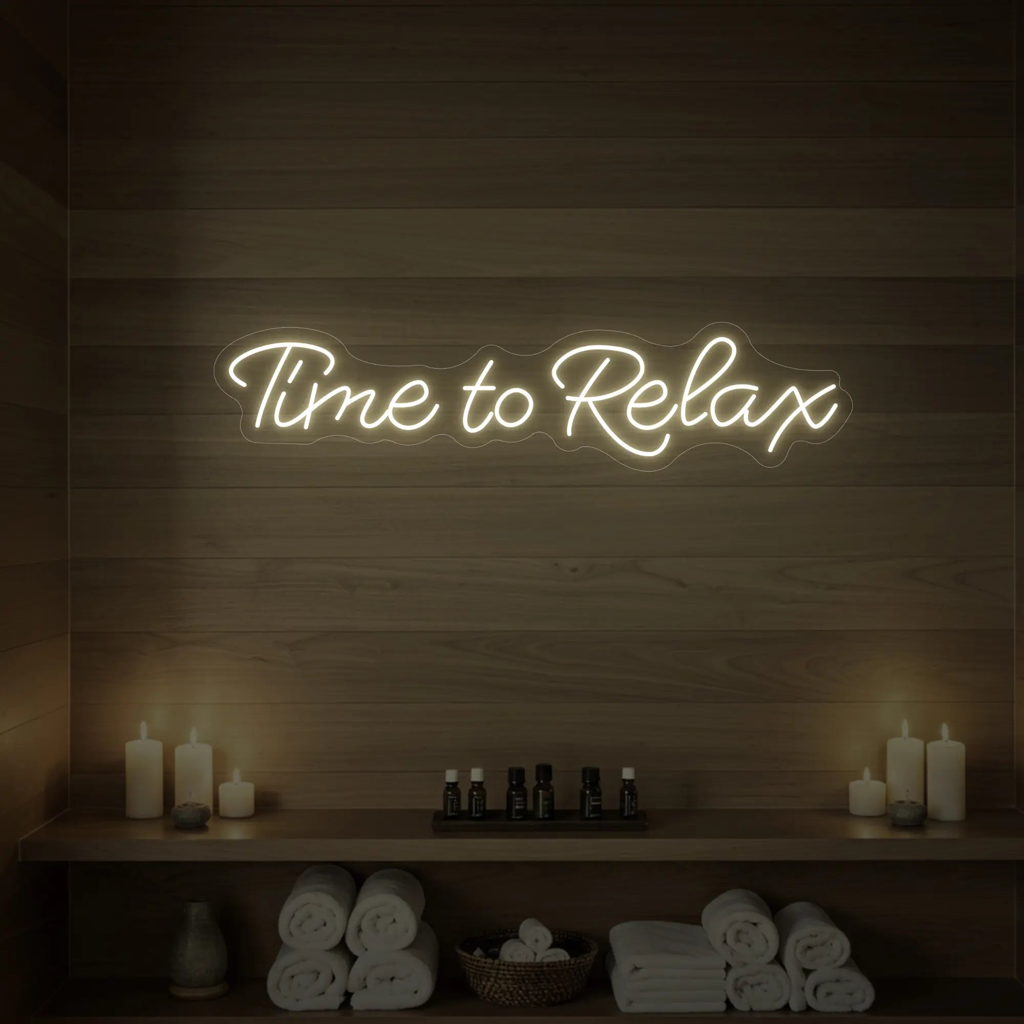 Photo of the 'Time to Relax' neon sign glowing in warm white against a styled interior wall.