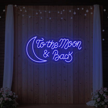 'To The Moon And Back' neon sign glowing in deep blue against a styled interior wall.