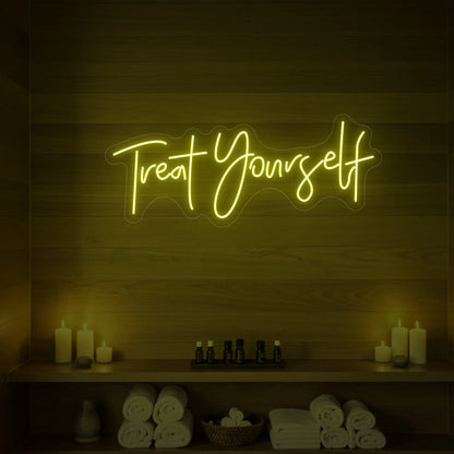 Photo of the 'Treat Yourself' neon sign glowing in lemon yellow against a styled interior wall.