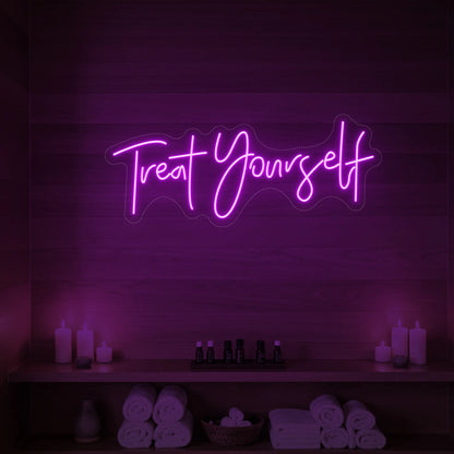 Photo of the 'Treat Yourself' neon sign glowing in deep pink against a styled interior wall.