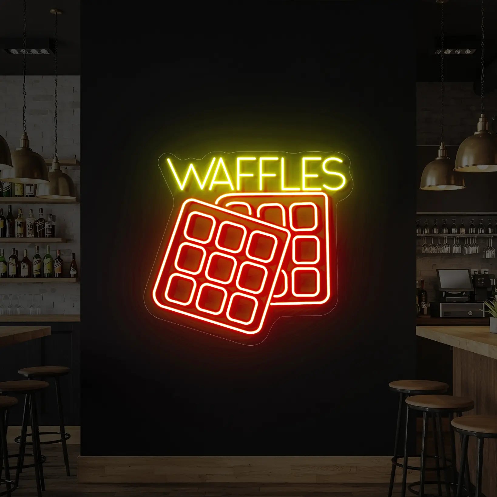 Photo of the 'Waffles' neon sign glowing in red and yellow against a styled interior wall.