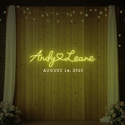 Photo of the 'Wedding First Names Custom Neon Sign' neon sign glowing in lemon yellow against a styled interior wall.