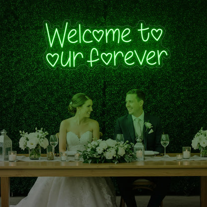  'Welcome To Our Forever' neon sign glowing in green against a styled interior wall.