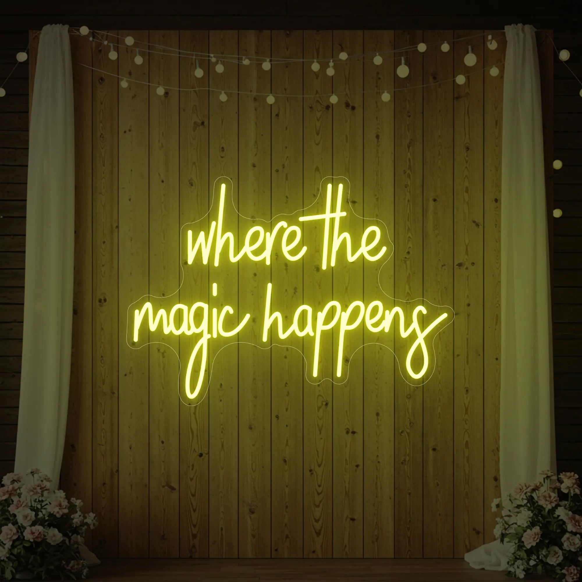  'Where The Magic Happens' neon sign glowing in lemon yellow against a styled interior wall.