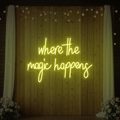  'Where The Magic Happens' neon sign glowing in lemon yellow against a styled interior wall.