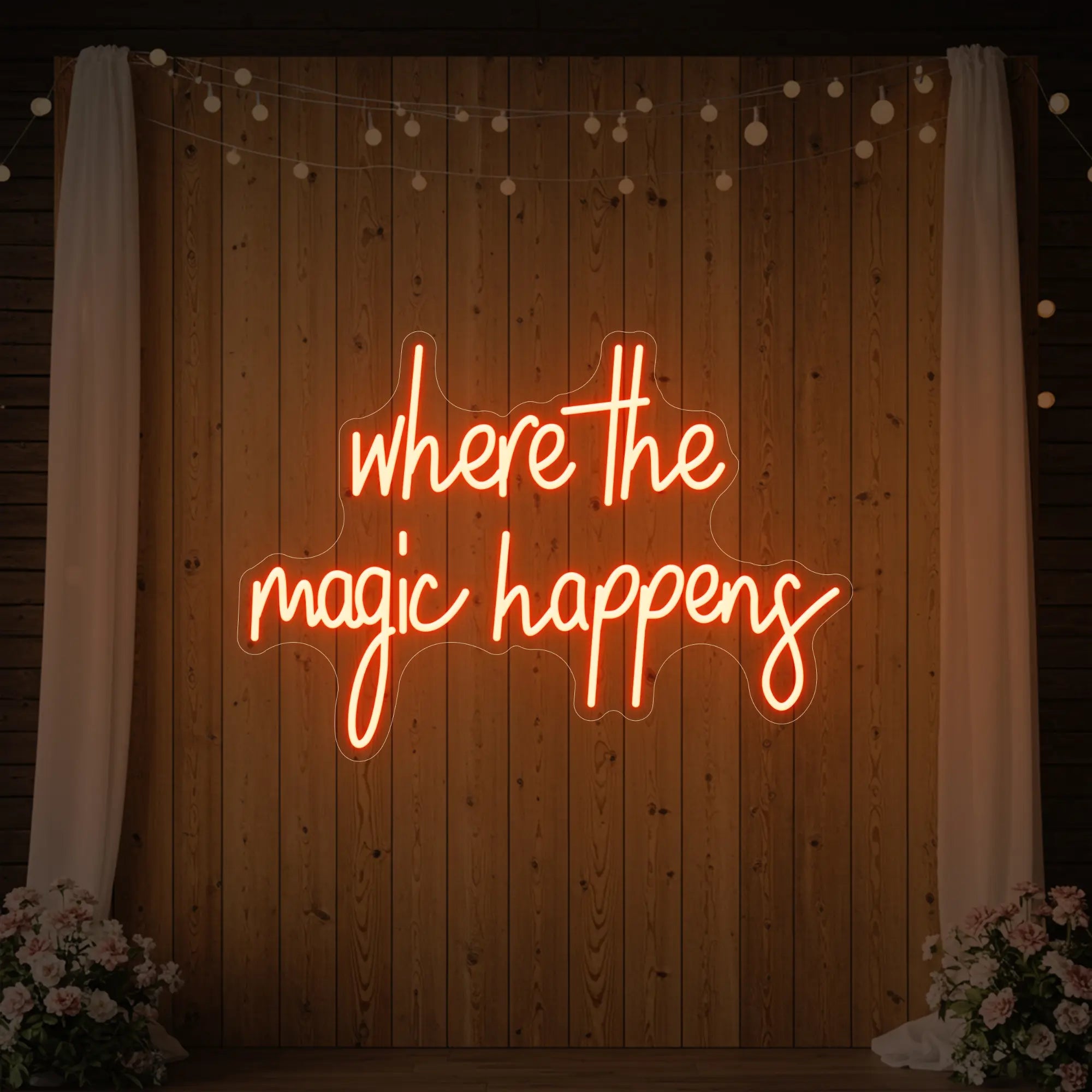  'Where The Magic Happens' neon sign glowing in golden yellow against a styled interior wall.