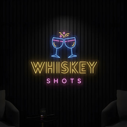 Photo of the 'Whiskey Shots' neon sign glowing in multi-color against a whiskey bar-inspired wall.