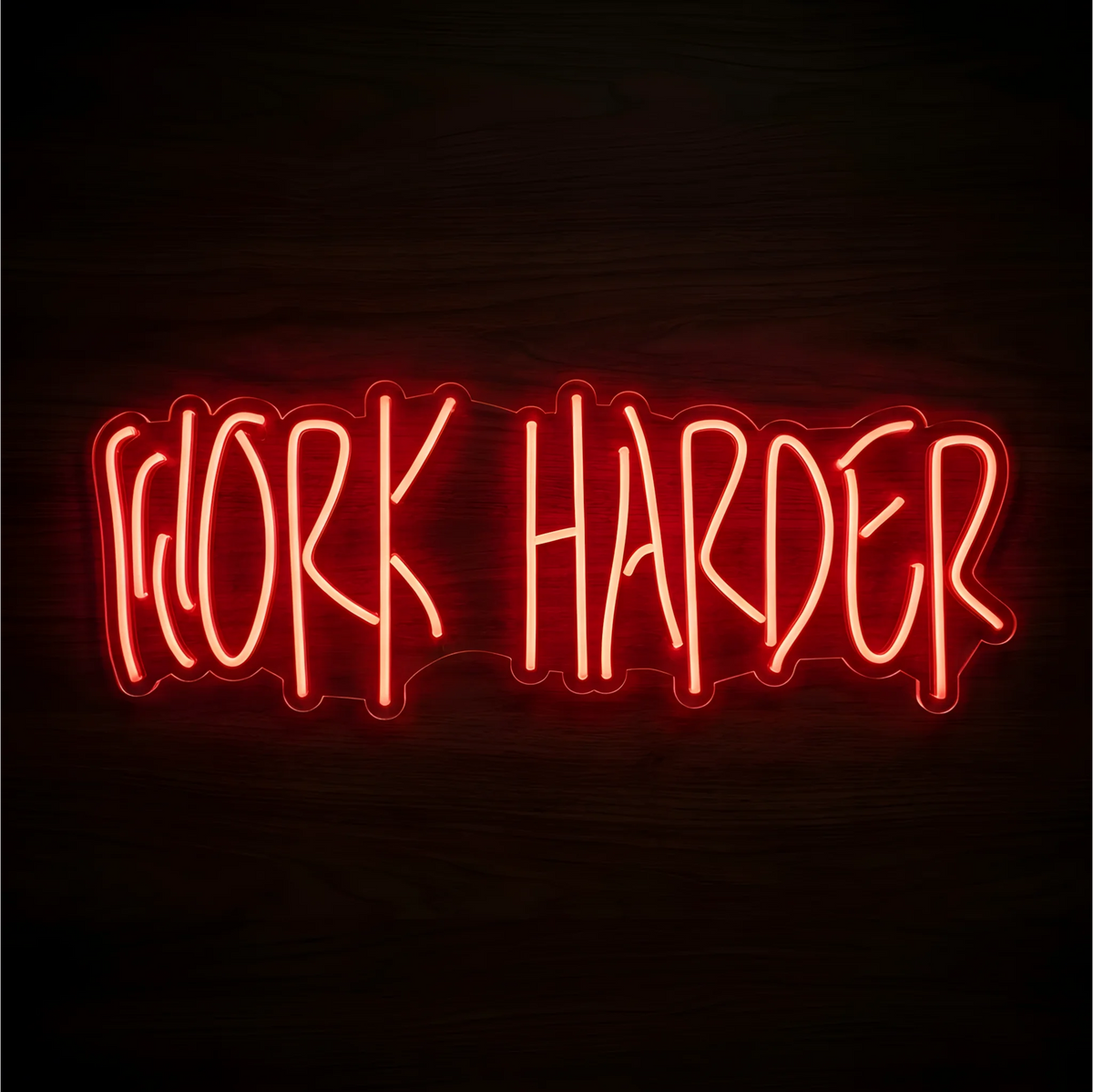 Work Harder LED Neon Sign glowing in red-orange lettering on clear acrylic against a dark wood background, suited to home offices and gym motivation walls.
