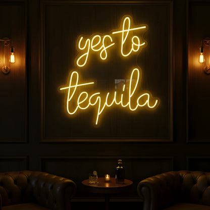 Photo of the 'Yes to Tequila' neon sign glowing in yellow against a tequila bar-inspired wall.