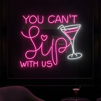 Photo of the 'Wine Time' neon sign glowing in multi-color against a cozy wine bar-inspired wall.