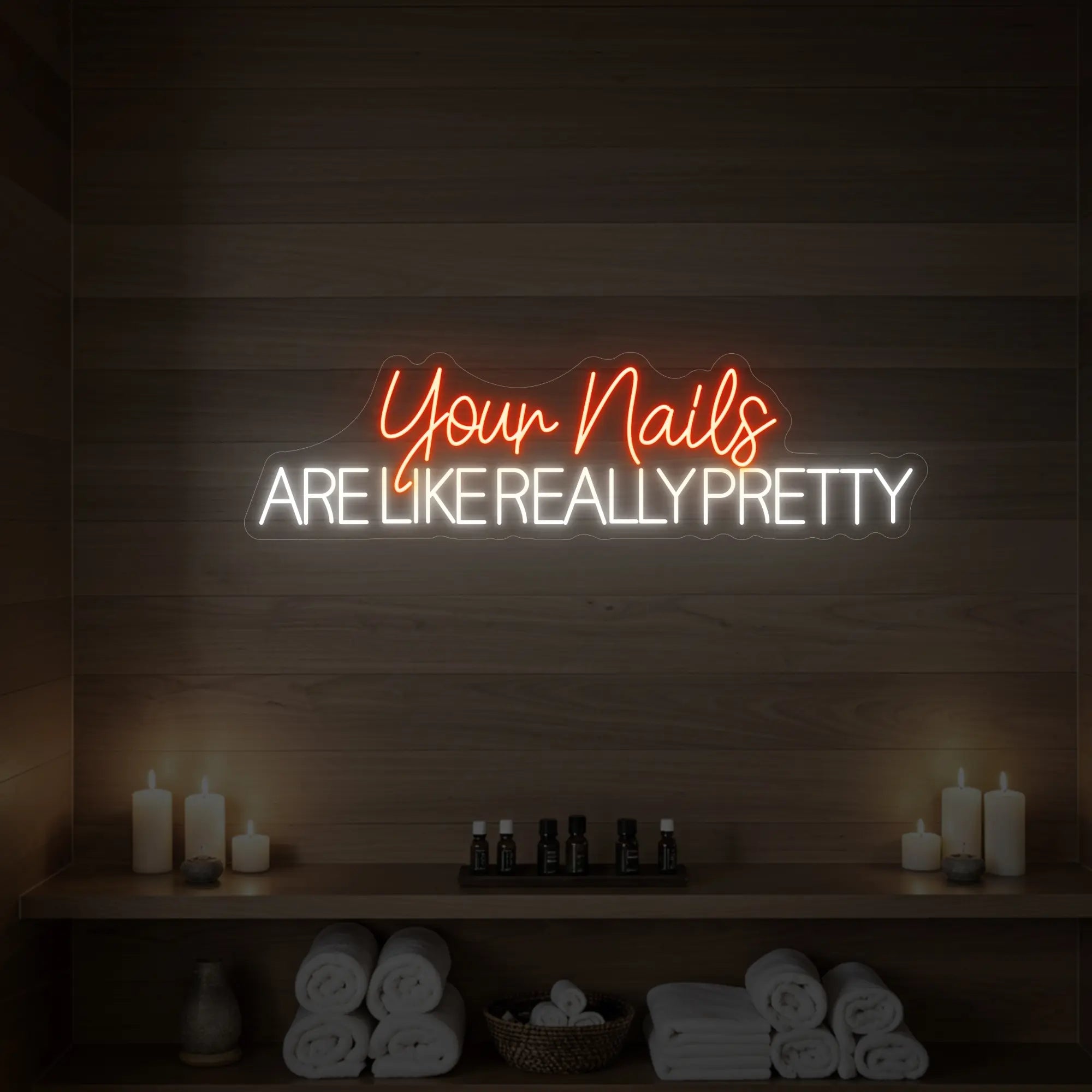 Photo of the 'Your Nails Are Like Really Pretty' neon sign glowing in golden yellow against a styled interior wall.