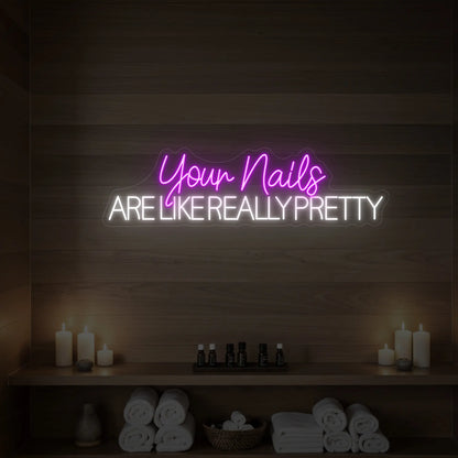 Photo of the 'Your Nails Are Like Really Pretty' neon sign glowing in deep pink against a styled interior wall.

