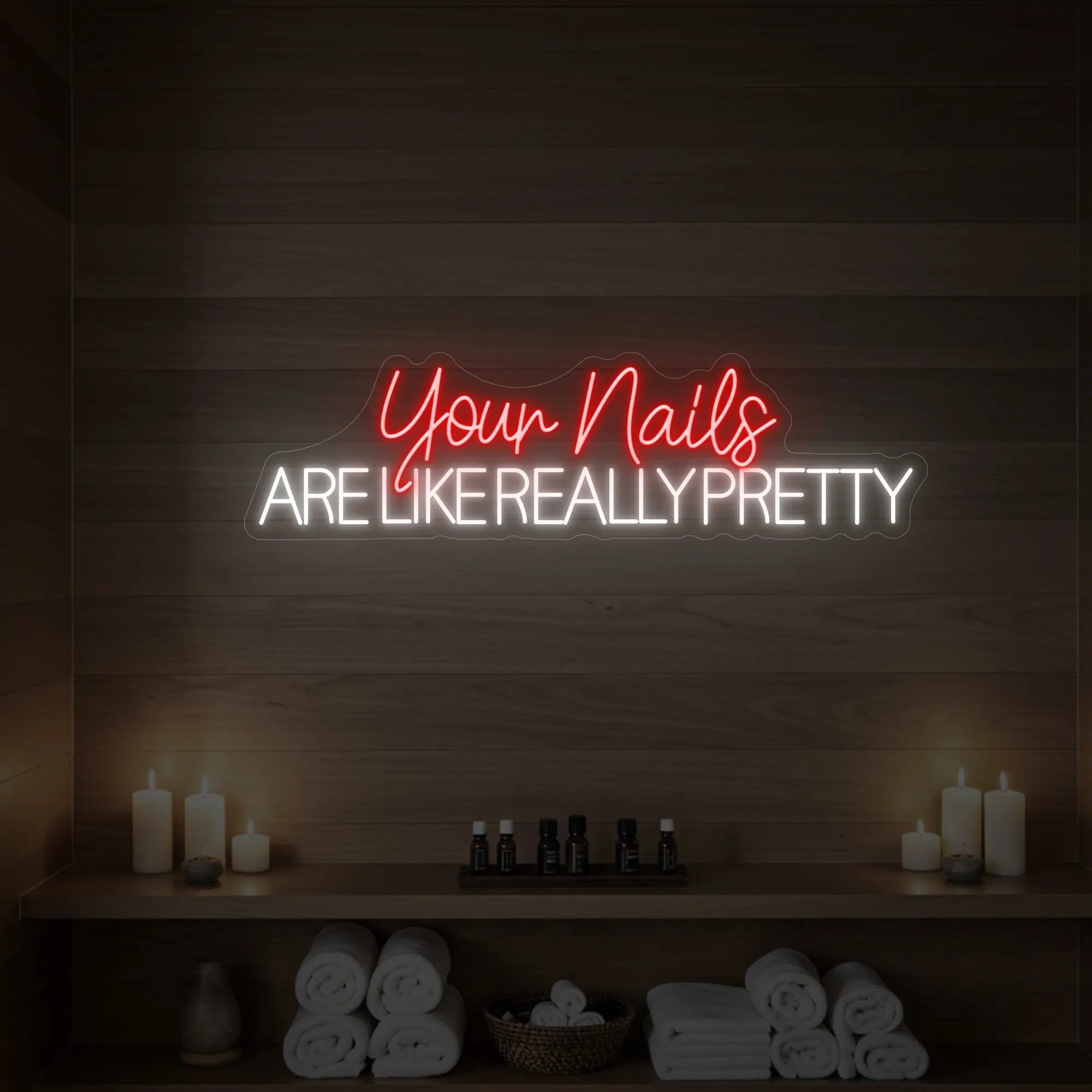 Photo of the 'Your Nails Are Like Really Pretty' neon sign glowing in red against a styled interior wall.